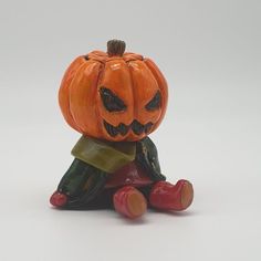 a small pumpkin sitting on top of a toy car