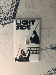 a light switch cover with darth vader and star wars images on the wall