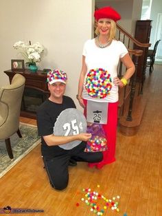 a man and woman are dressed up as clowns with hats on their heads, holding candy