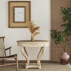 there is a small table and chair in the room next to a potted plant