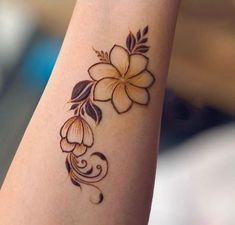 a woman's arm with a flower tattoo on it