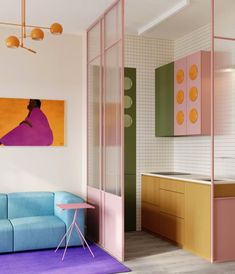 Small, colorful apartment in Berlin. On the kitchen side, cabinet doors are made of natural wood, while others are painted pastel pink and green. On the wall, small square white ceramic tiles. The living room features an orange pendant light, a pastel-blue sofa, a purple rug and a small pink table. Between the two, to divide the spaces, a glazed wall with pink frames and flutex glass. Earthy Materials, Interior Design Institute, Decor Salon, Deco Studio, Terrazzo Flooring, Kitchen Colors, Interior Inspo, Interior Spaces, Colorful Interiors