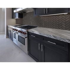 a kitchen with an oven, stove and cabinets in the middle of it's counter tops