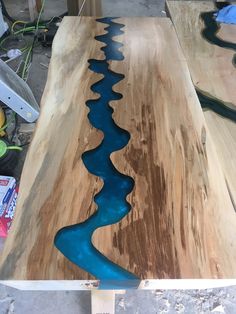 a wooden table with blue water flowing down it