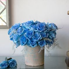 blue flowers in a vase on a table