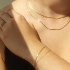 Laps of gold � the most fluid, aqueous chain of them all. A slinky, shining length of gold to wear on its own, or in a stack. You can indeed wear your Swimming Pool piece in a swimming pool � that is the benefit of solid 14k gold. Put it on, never take it off. Made with 100% recycled 14k solid gold chain. When not wearing your Swimming Pool piece, we suggest storing it flat, in its natural shape, which best suits herringbone chains. Dainty Gold Flexible Chain Bracelet, Gold Double Chain Bracelet For Party, Gold Dainty Snake Chain Bracelet, Gold Snake Chain Bracelet For Everyday Wear, Flexible Gold Chain Bracelet For Everyday, Minimalist Yellow Gold Bracelets With Double Chain, Minimalist Yellow Gold Bracelet With Double Chain, Everyday Flexible Gold Chain Bracelet, Gold Minimalist Double Chain Bracelet