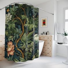 a bathroom with a shower curtain that has flowers and leaves on it, next to a bathtub