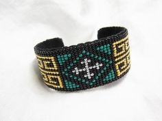 a beaded bracelet with a cross on it