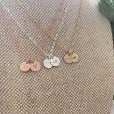 This beautiful dainty necklace features 2 of our Mini discs, 1 to contain a date, initial or (short) name/word of your choice, and the other is a disc with a love heart symbol. Mini Disc measures 9mm. 16", 18", 20" lengths with spring ring clasp. 14k Gold filled, 14k Rose gold filled or Sterling Silver. Available only in 1.5mm Tiny Block font. Handcrafted in Australia. Each piece is hand stamped & there may be slight variations such as with the letter alignment or spacing - this is not a defect Dainty Hand Stamped Charm Necklace For Anniversary, Dainty Hand-stamped Charm Necklace For Anniversary, Anniversary Dainty Hand-stamped Charm Necklace, Dainty Round Disc Charm Necklace For Personalized Gift, Dainty Hand Stamped Round Disc Necklace, Dainty Charm Necklace For Personalized Gift, Dainty Hand Stamped Round Disc Necklaces, Hand Stamped Round Pendant Necklace For Best Friend, Dainty Charm Necklace With Round Disc For Mother's Day