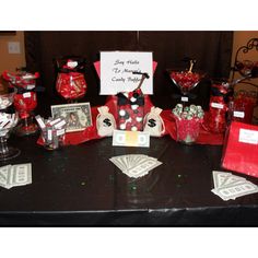 the table is set up with candy and cards for guests to sign their names on