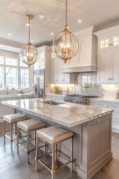 a large kitchen with marble counter tops and stools in it's center island