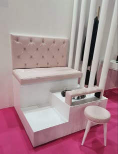 a pink and white bench sitting on top of a pink floor next to a chair