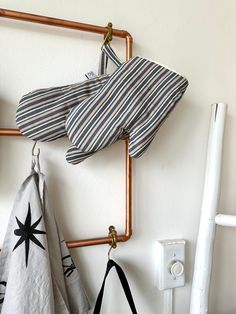 two towels hanging on the wall next to a towel rack