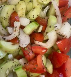 a salad with cucumbers, tomatoes and onions