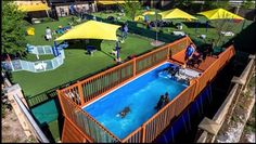 an aerial view of a swimming pool with people in it and yellow umbrellas on the roof