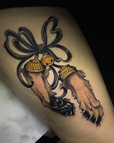 a woman's thigh with an image of a dog holding a bell on it