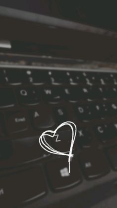 a heart drawn on the keyboard of a laptop