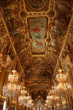 an ornate room with chandeliers and paintings on the ceiling