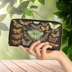 For carrying around all your credit cards, cash, and other essentials - look no further than this gorgeous dark forest floor motif zipper clutch wallet. Made with cruelty-free faux leather, this wallet comes packed with utility and style. Truly a design that will prove to be a daily staple that is unique and full of character, just like you! Mystical Vintage moths wallet, Forestcore Wallet, Dark Forest Witch Zipper Clutch Wallet, Magical Moths Clutch, Bugs, Naturecore Wallet, Dark Cottagecore, G Rectangular Zipper Wallet As Gift, Rectangular Wallets With Zipper Closure As Gift, Black Wallet With Zipper Closure As Gift, Black Wallets With Zipper Closure As Gift, Portable Multicolor Rectangular Wallet, Multicolor Rectangular Wallet, Bifold Wallet With Zipper Closure For Gift, Black Card Holder With Zipper Closure As Gift, Novelty Rectangular Wallets As Gifts