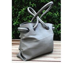 "Each of my bags is designed and constructed with lots of love, care and great attention to detail aiming superior craftsmanship.   Ashy Grey Medium Size Luxury Tote is made of high quality Italian genuine calfskin leather in ashy grey color. It has its unique art design and owing to special styling of its handles it surely would be perceived as an accessory.  Its shape is usual but stylish. Ashy Medium Size Luxury Tote will drive all eyes to look your way!  This Ashy Grey Tote has 2 inside pockets, magnetic snap closure and double medium sized handles and could be carried by hand or over the shoulder.   Details: Height - 24cm (9.4 inches) Top Width - 30cm (11.9 inches) Bottom Width - 29cm (11.4 inches) Depth (bottom) - 10cm (4 inches) Handle's Length - 40cm (15.7 inches) Inside Pockets - Black Leather Choker, Luxury Leather Bag, My Bags, Grey Tote, Leather Chokers, Gray Leather, Handmade Bag, Givency Antigona Bag, Lovely Earrings