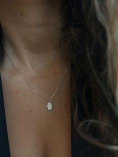 Elevate your style and embrace a touch of spirituality with our 14K Gold Hollow Hamsa Necklace. This captivating piece not only exudes timeless elegance but also carries a deep symbol of protection, bringing positive energy and good fortune into your life. ✨ Key Features ✨ Material: 14K Gold Chain Length:42 cm Diamond Carat Weight: 0.18 carats Diamond Clarity: SI (Slightly Included) Clasp Type: Lobster Clasp 🔸 Exquisite Craftsmanship 🔸 Crafted with utmost precision and attention to detail, thi White Gold Pendant Necklace Hand Set, White Gold Spiritual Necklace With Gemstone, Spiritual White Gold Gemstone Necklace, Spiritual White Gold Necklace For Anniversary, Spiritual Yellow Gold Birthstone Necklace, Dainty Hand Set Sterling Silver Jewelry, White Sterling Silver Amulet Necklace, Dainty Hand-set Sterling Silver Jewelry, Hand Set White Gold Necklace For Gift