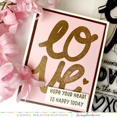 a card with the words love is happy today on it and pink flowers next to it