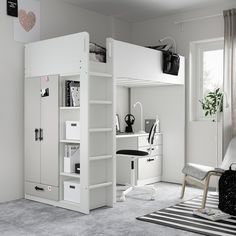 a white loft bed sitting in a bedroom next to a desk and chair on top of a rug