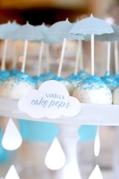 cake pops with blue sprinkles and umbrella decorations