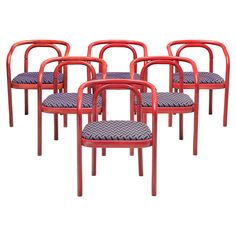 six red chairs with blue upholstered seats