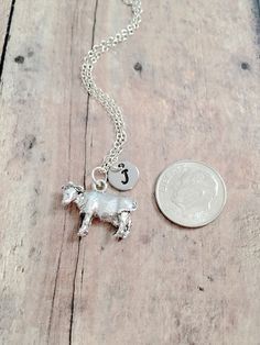 "This listing is for a hand stamped initial necklace featuring a 7/10\" x 1/2\" silver plated pewter cow charm & 3/10\" stainless steel initial pendant. The silver plated chain is 18\" long, but can be made to your desired length- see last photo in listing. Please indicate chain length you would like in the 'notes to seller' section at checkout. All items are lead & nickel free. Message me with any questions, thank you! Add an initial to any necklace https://www.etsy.com/listing/17046159 Cow Jewelry, Cow Necklace, Farm Jewelry, Cow Gifts, Tyler Tx, Animal Pendant, State Fair, Initial Pendant, Initial Necklace