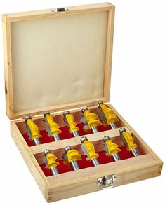 a wooden box filled with yellow and red drillets in it's opening compartments