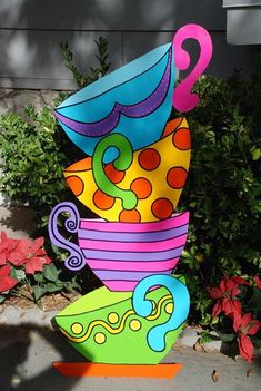 a colorful sculpture sitting on top of a sidewalk