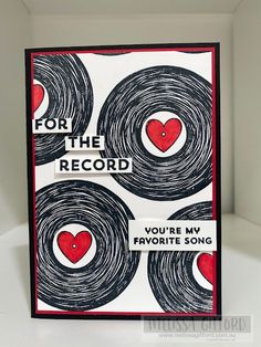 a handmade card with black and white circles, red heart on the center reads for the record you're my favorite song