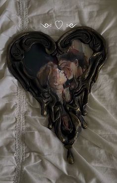 a heart shaped photo frame with two people in it