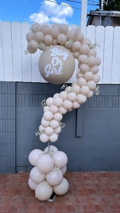 a balloon arch with white balloons and baby on it