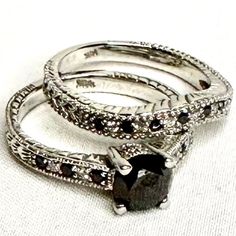 three wedding rings with black and white stones