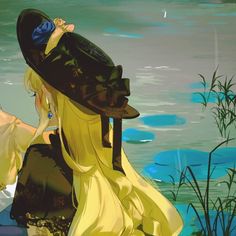 a woman in a yellow dress and black hat sitting on the ground next to water