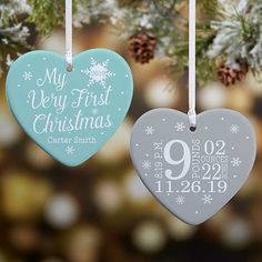 two heart shaped ornaments hanging from a christmas tree