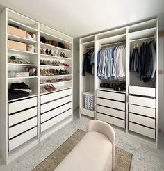 a white closet filled with lots of clothes and shoes next to a rug on the floor