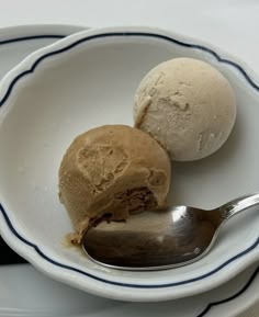 two scoops of ice cream in a white bowl