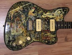 an electric guitar covered in stickers and pictures