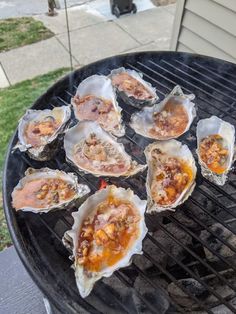 several oysters are being cooked on the grill