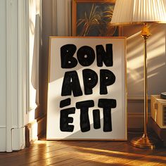 a sign that says bon app ett on it next to a lamp in a room