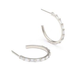 Experience the perfect blend of style and versatility with our baguette hoop earrings that come in your choice of high-quality 18K gold plated or .925 sterling silver. These exquisite earrings feature mesmerizing baguette-cut cubic zirconia, delicately encased in a radiant gold-plated hoop design. 18K Gold or .925 Sterling Silver Cubic Zirconia Baguettes Size: .81" White Gold Hoop Earrings Baguette Cut, Modern Hoop Jewelry With Baguette Diamonds, Modern Sterling Silver Baguette Cut Earrings, Small Hoop Huggie Earrings With Baguette Diamonds, Sterling Silver Hoop Earrings With Baguette Diamonds, Baguette Diamond Small Hoop Earrings, Small Hoop Earrings With Baguette Diamonds, Fine Jewelry Small Hoop Earrings With Baguette Diamonds, Small Hoop Earrings With Baguette Diamonds For Gift