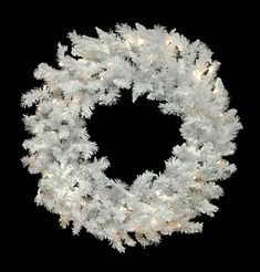 a white christmas wreath on a black background