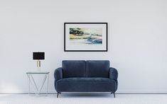 a living room with a blue chair and a lamp on the side table next to it