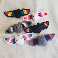 four crocheted animals are laying on a white sheet