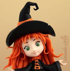 a close up of a doll wearing a witches hat