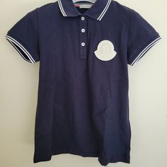 100% Authentic Brand New With Tags, Excellent Condition Large Logo In Front Moncler Maglia Polo Manica Corta Casual Fitted Tops With Logo Detail, Summer Tops With Logo Detail, Fitted Blue Top With Embroidered Logo, Blue Polo Collar Top With Embroidered Logo, Luxury Navy Sporty Polo Shirt, Sporty Moisture-wicking Polo Shirt, Moncler T Shirt, Blue Moisture-wicking Polo Shirt With Collar, Moncler Women