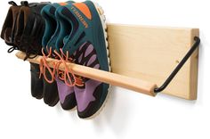 a wooden shoe rack with several pairs of shoes hanging on it